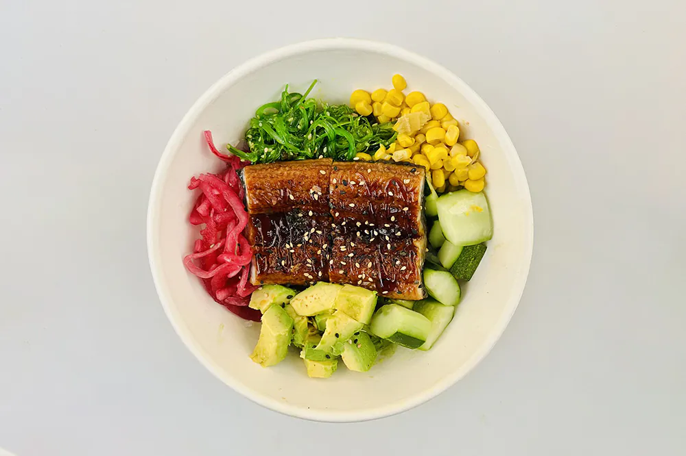 Grilled eel poke bowl with avocado, corn, cucumber and seaweed salad