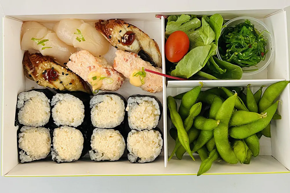 Sushi bento box with scallop, eel, roll, edamame and side salad